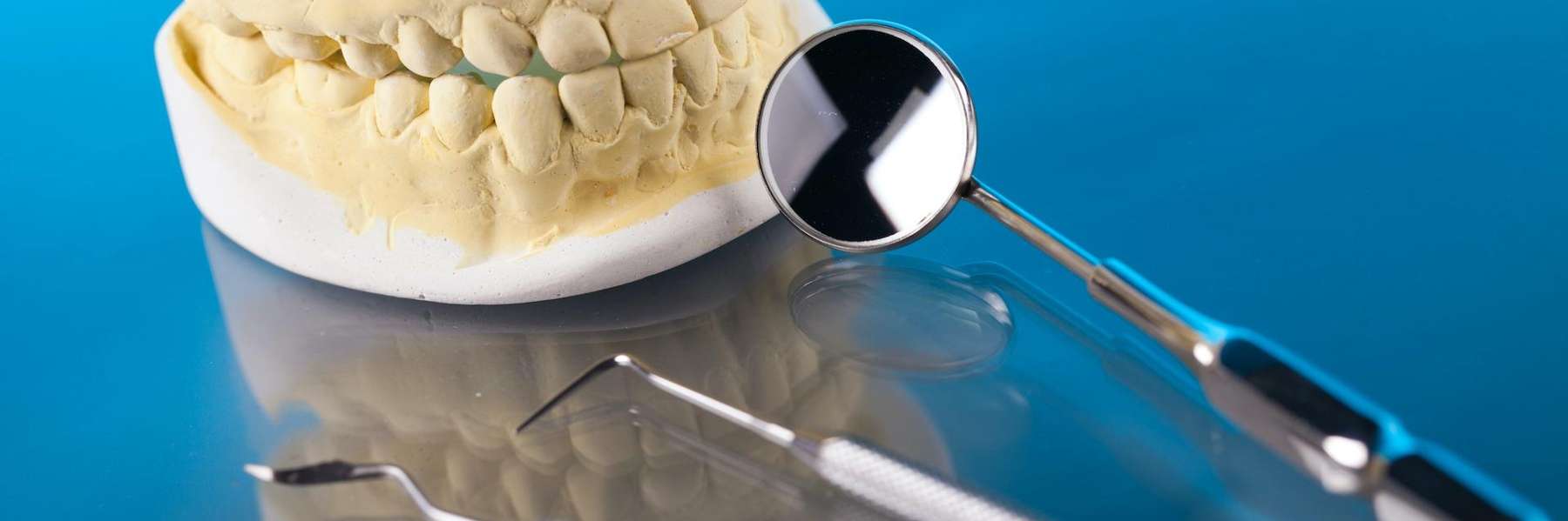 Dental tools next to a mold of teeth, fishers indiana