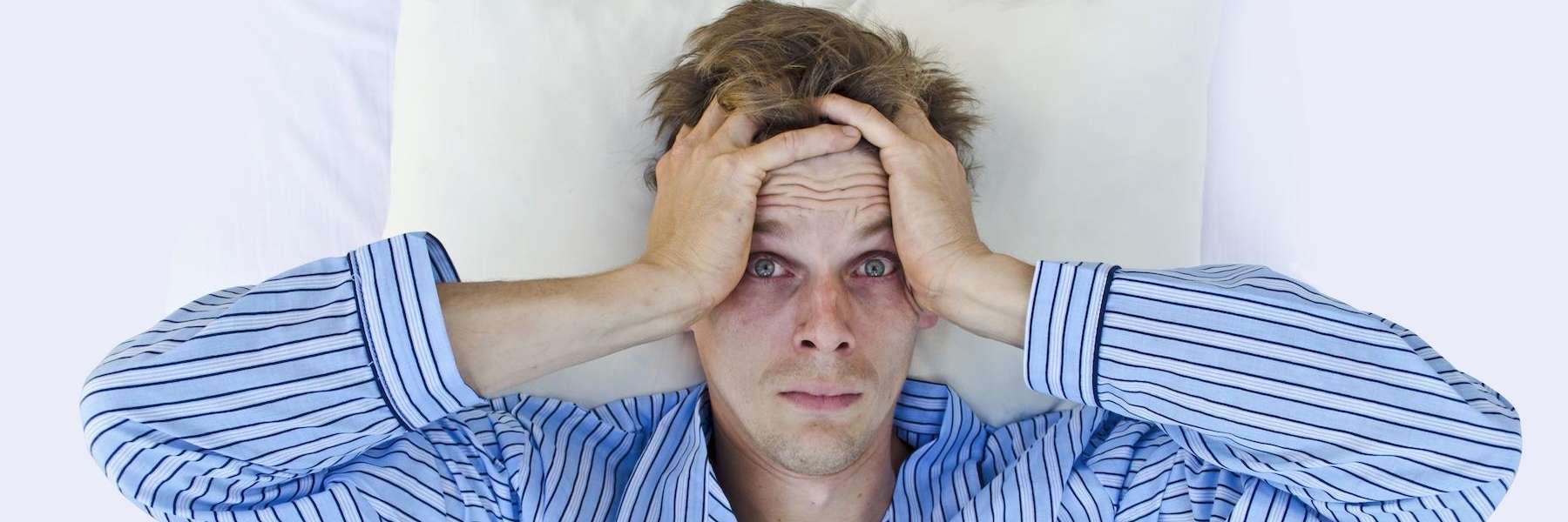 Man with hands on head laying down, fishers in